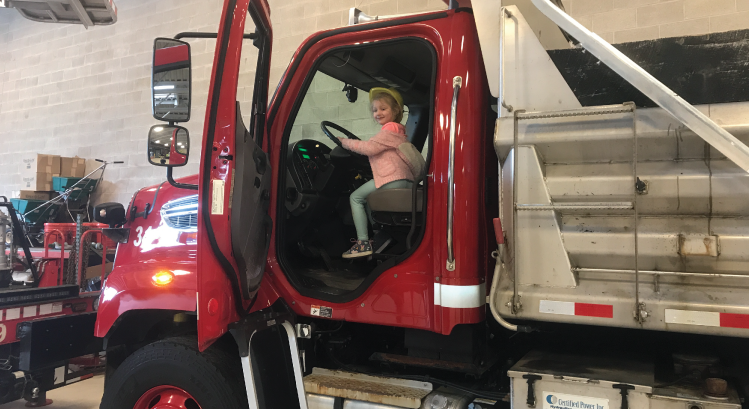 Child in red work truck