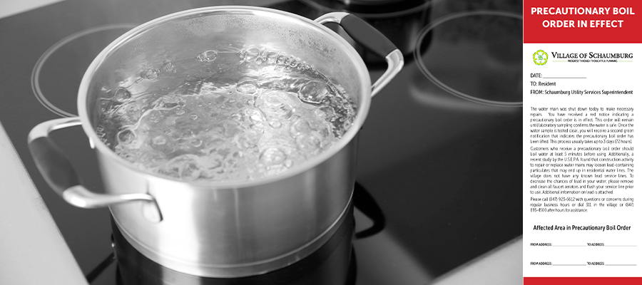 A pot of water boils on an electric stove next to a precautionary boil order notice letter